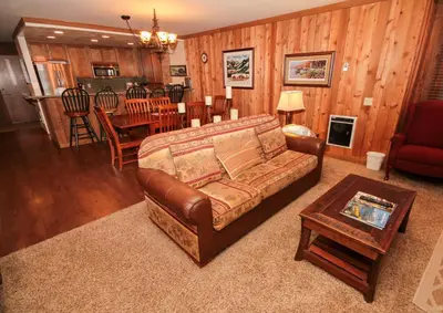 a living room with a leather couch and a table at Mountainback 49 Den in Mammoth Lakes