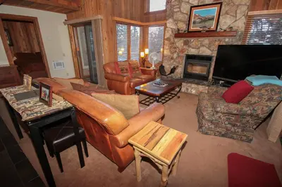 a living room with leather furniture and a fireplace at Mountainback 52 Loft Corner in Mammoth Lakes