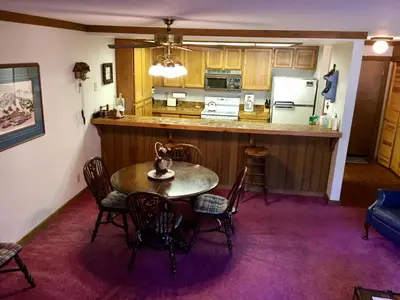 a kitchen and dining room with a table and chairs at Mountainback #74 in Mammoth Lakes
