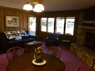 a living room with a table and a couch at Mountainback #74 in Mammoth Lakes