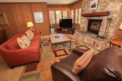 a living room with a couch and a fireplace at Mountainback 73 Den in Mammoth Lakes