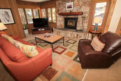 a living room with two chairs and a fireplace at Mountainback 73 Den in Mammoth Lakes