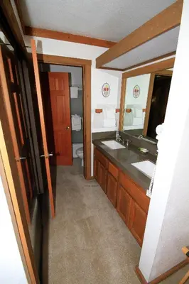 a bathroom with a sink and a mirror at Mountainback 72 Corner Unit in Mammoth Lakes