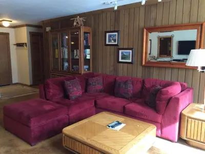 a living room with a purple couch and a table at Mountainback #71 in Mammoth Lakes
