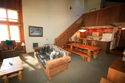 a living room with a couch and a table at Mountainback 63 Loft Den in Mammoth Lakes
