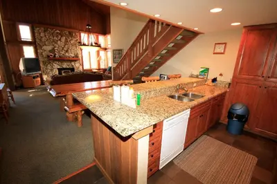 a kitchen with a sink and a staircase at Mountainback 63 Loft Den in Mammoth Lakes