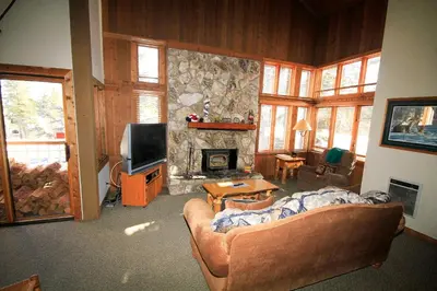 a living room with a couch and a fireplace at Mountainback 63 Loft Den in Mammoth Lakes