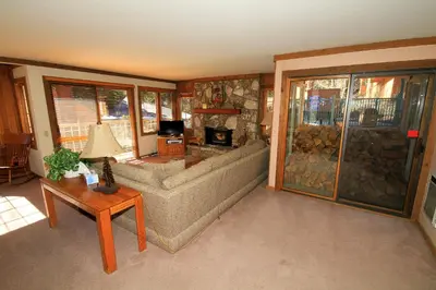 a living room with a couch and a fireplace at Mountainback 60 Corner Unit in Mammoth Lakes