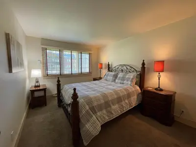 a bedroom with a bed with two night stands and two lamps at Mountainback 57 Den in Mammoth Lakes