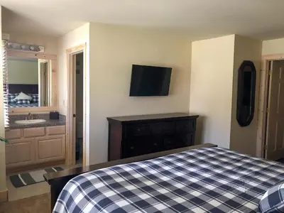 a bedroom with a bed and a tv on the wall at Mountainback 57 Den in Mammoth Lakes