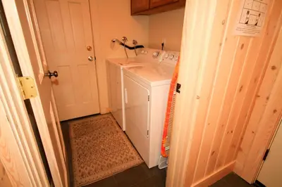 a small bathroom with a washer and dryer in it at Mountainback 57 Den in Mammoth Lakes