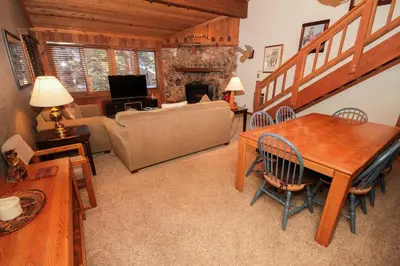 a living room with a couch and a table and a fireplace at Mountainback 53 Loft in Mammoth Lakes
