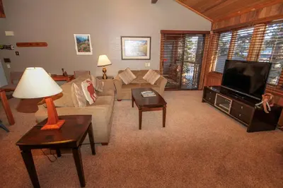 a living room with a couch and a tv at Mountainback 53 Loft in Mammoth Lakes