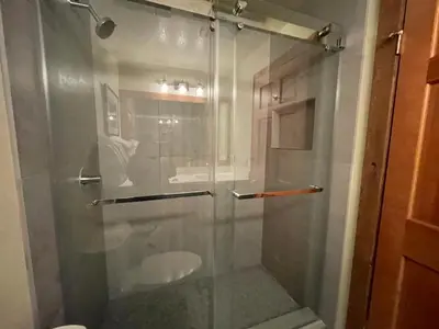 a shower with a glass door in a bathroom at Mountainback 53 Loft in Mammoth Lakes