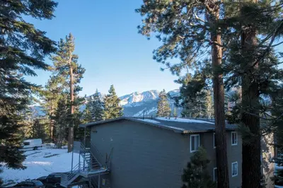 a house in the woods with a mountain at Mountainback 53 Loft in Mammoth Lakes
