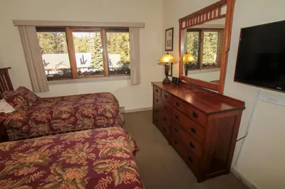 a bedroom with a bed and a dresser and a television at Mountainback 12 2 Bdrm 3 Ba Loft - Pet Ok in Mammoth Lakes