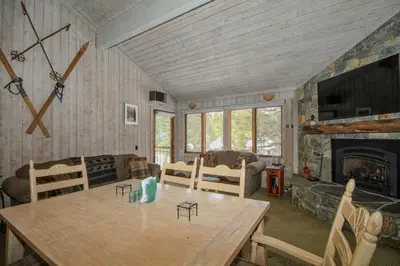 a living room with a table and a fireplace at Mountainback 12 2 Bdrm 3 Ba Loft - Pet Ok in Mammoth Lakes