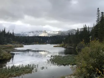 a river with a snow covered mountain in the background at Mountainback 12 2 Bdrm 3 Ba Loft - Pet Ok in Mammoth Lakes