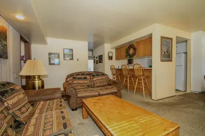 a living room with a couch and a table at Discovery 4 125 in Mammoth Lakes