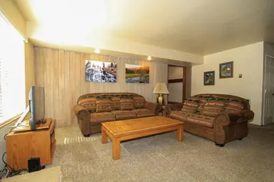 a living room with two couches and a tv at Discovery 4 125 in Mammoth Lakes