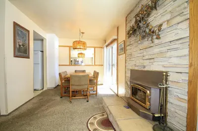 a living room with a table and a fireplace at Discovery 4 125 in Mammoth Lakes