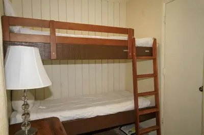 a bunk bed in a room with a lamp and a lamp at Discovery 4 117 in Mammoth Lakes