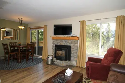 a living room with a fireplace with a television above it at Discovery 4 117 in Mammoth Lakes