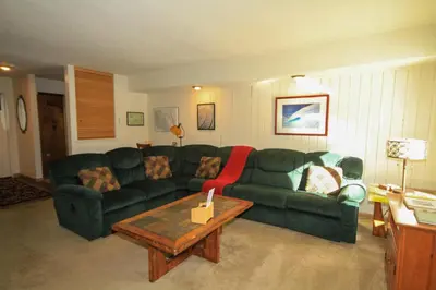 a living room with a green couch and a coffee table at Discovery 4 115 in Mammoth Lakes