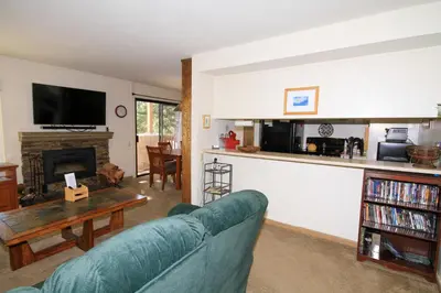a living room with a couch and a fireplace at Discovery 4 115 in Mammoth Lakes
