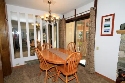 a dining room with a wooden table and chairs at Discovery 4 113 in Mammoth Lakes