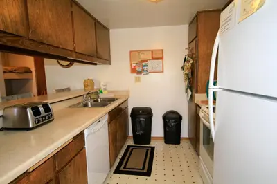 a kitchen with a sink and a white refrigerator at Discovery 4 113 in Mammoth Lakes