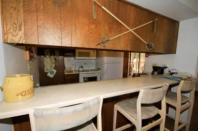 a kitchen with a counter with chairs around it at Discovery 4 113 in Mammoth Lakes