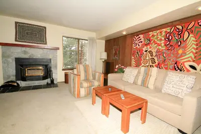 a living room with a couch and a fireplace at Discovery 4 133 in Mammoth Lakes