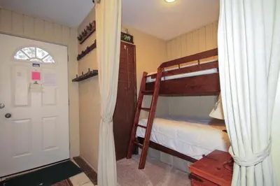 a bedroom with two bunk beds and a white door at Discovery 4 137 in Mammoth Lakes