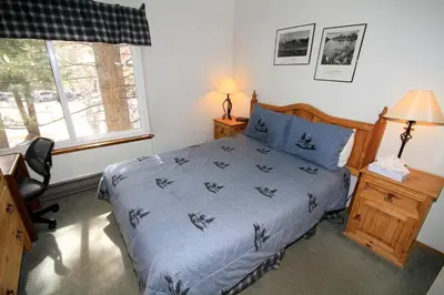 a bedroom with a bed and a desk and a window at Horizons 4 140 1 Bedroom Loft 1 Bath in Mammoth Lakes