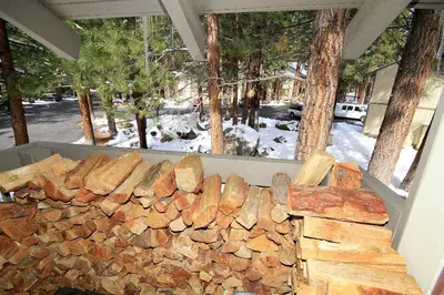 a pile of fire wood sitting next to a window at Horizons 4 140 1 Bedroom Loft 1 Bath in Mammoth Lakes