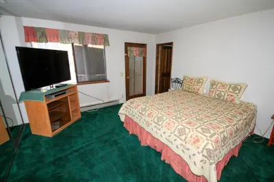 a bedroom with a bed and a flat screen tv at Forest Creek 3 Pet accepted in Mammoth Lakes