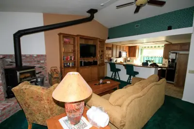 a living room with a couch and a table with a lamp at Forest Creek 3 Pet accepted in Mammoth Lakes