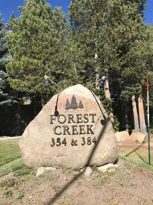a sign for the forest creek sign on a rock at Forest Creek 3 Pet accepted in Mammoth Lakes