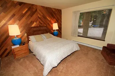 a bedroom with a bed and two lamps and a window at Discovery 4 153 in Mammoth Lakes