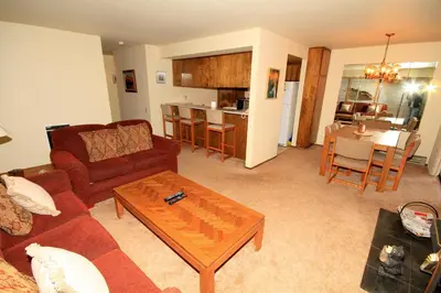 a living room with a couch and a table at Discovery 4 153 in Mammoth Lakes