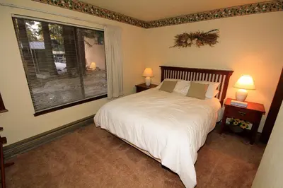 a bedroom with a bed and a large window at Discovery 4 153 in Mammoth Lakes