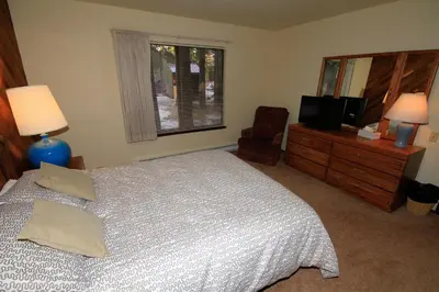 a bedroom with a bed and a television and a window at Discovery 4 153 in Mammoth Lakes