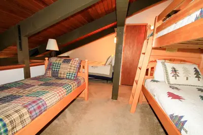 a bedroom with two bunk beds in a house at Discovery 4 152 Loft Pet Ok in Mammoth Lakes
