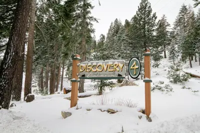 a sign in the snow in a forest at Discovery 4 152 Loft Pet Ok in Mammoth Lakes