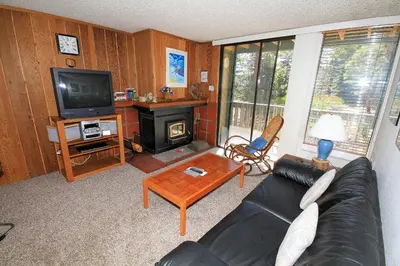 a living room with a couch and a television at Crestview 17 in Mammoth Lakes