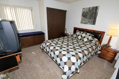 a bedroom with a bed and a flat screen tv at Crestview 17 in Mammoth Lakes