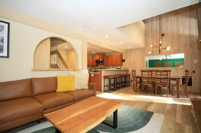 a living room and kitchen with a couch and a table at Mammoth Ski Racquet Club 86 - Pet Friendly in Mammoth Lakes