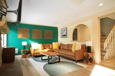a living room with a couch and a table at Mammoth Ski Racquet Club 86 - Pet Friendly in Mammoth Lakes