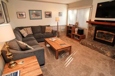 a living room with a couch and a fireplace at Mammoth Ski & Racquet Club #84 in Mammoth Lakes